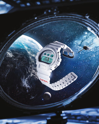 DW6900NASA237 G-SHOCK watch - An Era Defining Mission: Matte white, NASA logo on bands, Earth engraving on case back, American flag on band loop.