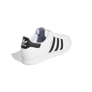 White Adidas sneaker with black stripes on a white background