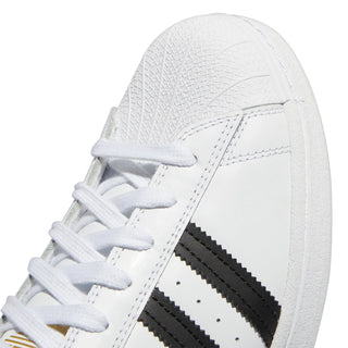 White sneaker with black stripes on a white background