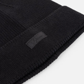 Black Dime ribbed beanie with small white cursive logo.