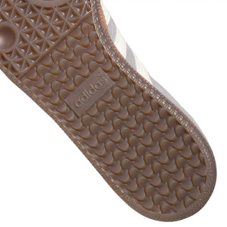 Close-up of Adidas sandal sole with brand logo on a light gray background