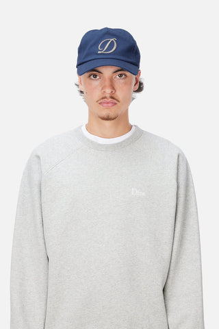 Angled front view of Dime Cursive D Worker Cap in Marine blue with a raised cream embroidered cursive D logo and curved brim