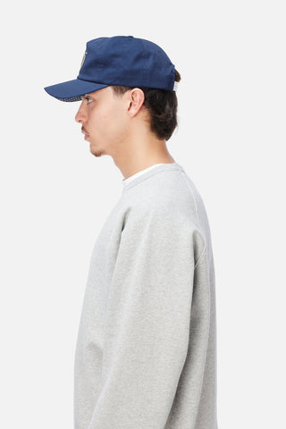 Angled front view of Dime Cursive D Worker Cap in Marine blue with a raised cream embroidered cursive D logo and curved brim