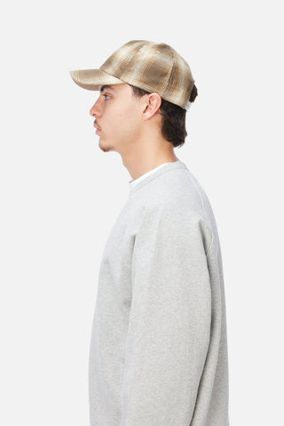 Angled front view of Dime Flannel Low Pro Cap in Brown plaid with a cream embroidered Dime logo and curved brim