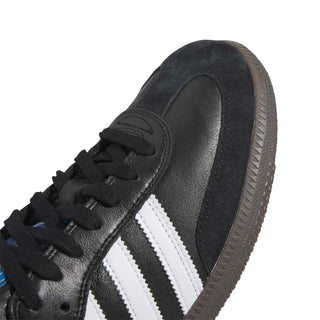 Black Adidas sneaker with white stripes on a white background
