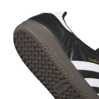 Close-up of a black and white Adidas sneaker sole with brand logo.