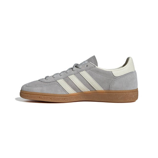Gray sneaker with white stripes on a white background