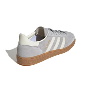 Gray Adidas sneaker with white stripes on a light gray background