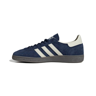 Navy blue Adidas sneaker with white stripes on a light gray background