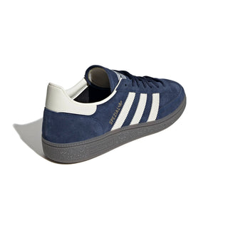 Navy blue Adidas sneaker with white stripes on a white background