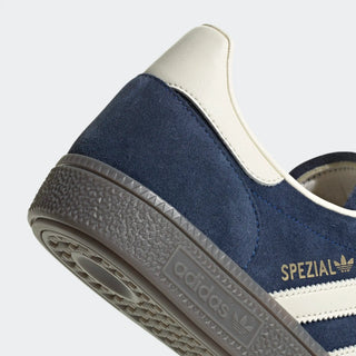 Navy and white Adidas sneaker with 'Spezial' branding on a light gray background