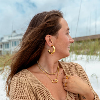 Large polished gold hoop earrings with classic silhouette.