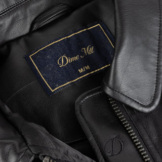 Dime black quilted jacket with wavy debossed pattern and oversized logo patch.