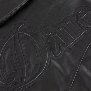 Dime black quilted jacket with wavy debossed pattern and oversized logo patch.