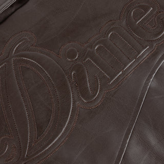 Dime brown quilted jacket with wavy debossed pattern and oversized logo patch.
