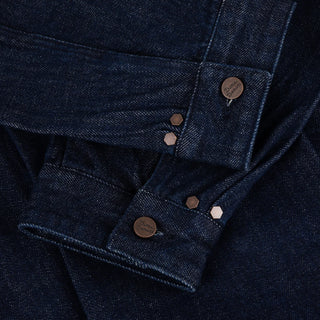 Dime Pleated Denim Jacket in Indigo — 100% cotton with front pleats, custom shanks, hexagon rivets, metal button closure, and woven label branding at hem