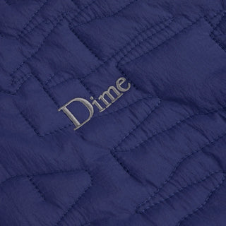 Front view of Dime Reversible Insulated Jacket in Blue Iris with a geometric quilted pattern, hood, zippered pockets, chest logo, and hem cinches