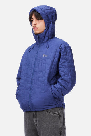 Front view of Dime Reversible Insulated Jacket in Blue Iris with a geometric quilted pattern, hood, zippered pockets, chest logo, and hem cinches