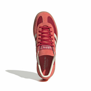 adidas Originals Handball Spezial in Team Victory Red/Off White/Preloved Scarlet — soft suede and textile upper with rubber outsole, lace closure, and Trefoil tongue logo celebrating the iconic 1979 heritage.

