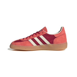 adidas Originals Handball Spezial in Team Victory Red/Off White/Preloved Scarlet — soft suede and textile upper with rubber outsole, lace closure, and Trefoil tongue logo celebrating the iconic 1979 heritage.

