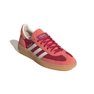 adidas Originals Handball Spezial in Team Victory Red/Off White/Preloved Scarlet — soft suede and textile upper with rubber outsole, lace closure, and Trefoil tongue logo celebrating the iconic 1979 heritage.

