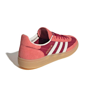 adidas Originals Handball Spezial in Team Victory Red/Off White/Preloved Scarlet — soft suede and textile upper with rubber outsole, lace closure, and Trefoil tongue logo celebrating the iconic 1979 heritage.

