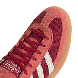 adidas Originals Handball Spezial in Team Victory Red/Off White/Preloved Scarlet — soft suede and textile upper with rubber outsole, lace closure, and Trefoil tongue logo celebrating the iconic 1979 heritage.

