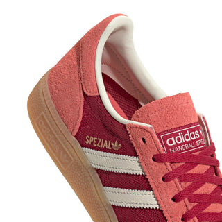 adidas Originals Handball Spezial in Team Victory Red/Off White/Preloved Scarlet — soft suede and textile upper with rubber outsole, lace closure, and Trefoil tongue logo celebrating the iconic 1979 heritage.

