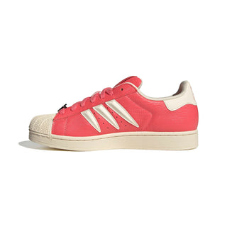 adidas Originals Pokémon Superstar II "Charmeleon" in Preloved Scarlet/Preloved Scarlet/Cream White — full leather upper with Charmeleon scale-like skin texture, 3-Stripes shaped into claws, Charmeleon character on tongue label, sockliner, and lace jewel