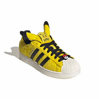 adidas Originals Pokémon Superstar II "Pikachu" in Yellow/Yellow/Core Black — yellow furry upper, Pikachu tail lace jewel, Pikachu ears on tongue, full textile lining and rubber outsole on the classic Superstar II silhouette