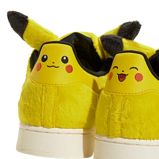 adidas Originals Pokémon Superstar II "Pikachu" in Yellow/Yellow/Core Black — yellow furry upper, Pikachu tail lace jewel, Pikachu ears on tongue, full textile lining and rubber outsole on the classic Superstar II silhouette