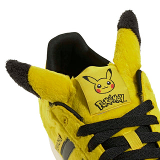 adidas Originals Pokémon Superstar II "Pikachu" in Yellow/Yellow/Core Black — yellow furry upper, Pikachu tail lace jewel, Pikachu ears on tongue, full textile lining and rubber outsole on the classic Superstar II silhouette