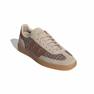 Close-up of adidas Originals Handball Spezial in Beige/Khaki Three/Dusky Bronze showing houndstooth fabric, brown stripes, gold Spezial branding, and a gum sole.