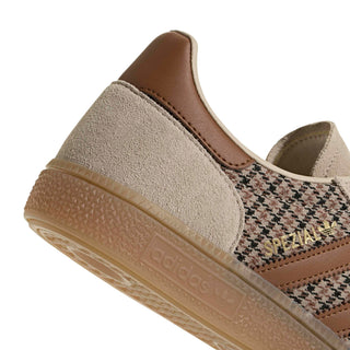 Close-up of adidas Originals Handball Spezial in Beige/Khaki Three/Dusky Bronze showing houndstooth fabric, brown stripes, gold Spezial branding, and a gum sole.