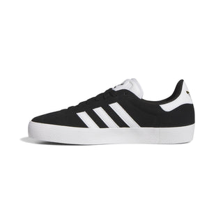 Adidas Gazelle ADV skate shoe in Core Black, Cloud White, and Gold Metallic — low-profile suede upper with cupsole construction and reinforced ollie zone.
