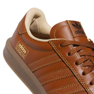 adidas Skateboarding Glenburn Shoes in Dusky Bronze/Gold Metallic/Gum — terrace-inspired skate shoe with leather upper, EVA heel cushioning, Three Stripes branding, and rubber outsole