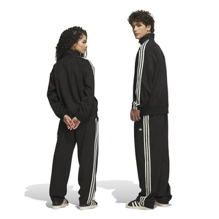 adidas Skateboarding Vintage Superfire Track Pant in Black and Cream White with loose fit and classic track styling.