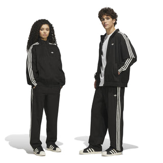 adidas Skateboarding Vintage Superfire Track Pant in Black and Cream White with loose fit and classic track styling.