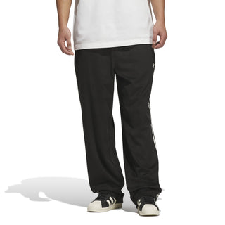 adidas Skateboarding Vintage Superfire Track Pant in Black and Cream White with loose fit and classic track styling.