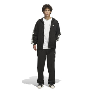 adidas Skateboarding Vintage Superfire Track Pant in Black and Cream White with loose fit and classic track styling.