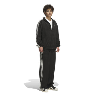 adidas Skateboarding Vintage Superfire Track Pant in Black and Cream White with loose fit and classic track styling.
