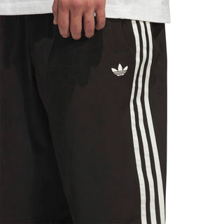 adidas Skateboarding Vintage Superfire Track Pant in Black and Cream White with loose fit and classic track styling.
