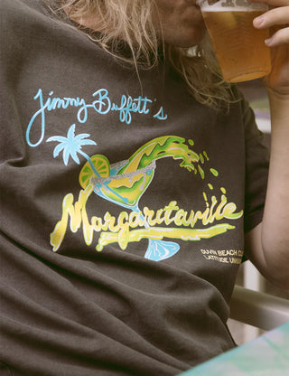 "Duvin x Margaritaville Please Return Tee in Black — relaxed fit beach lifestyle collab tee from Duvin Design Co."