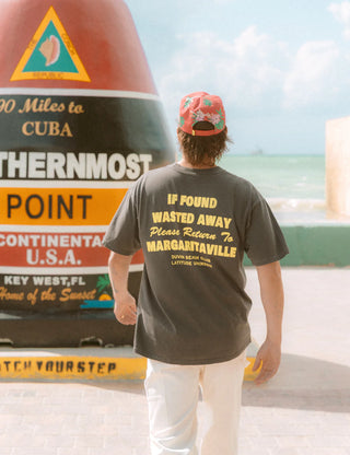 "Duvin x Margaritaville Please Return Tee in Black — relaxed fit beach lifestyle collab tee from Duvin Design Co."