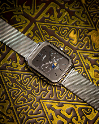 CASIO MTPM305MC-8AV analog watch with moon phase display, gold-tone stainless steel mesh band, date and day dials, 50m water resistance, and classic design