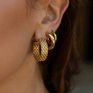 Polished gold hoop earrings with rounded classic silhouette.