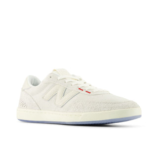 White sneaker with a red label on a white background