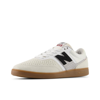 White sneaker with black logo and brown sole on a white background