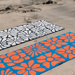 Nomadix Organic Cotton Beach Towel in Lazy Daisy Black — plush, absorbent, Fair Trade Certified™, 100% organic cotton, 30" x 72.5"