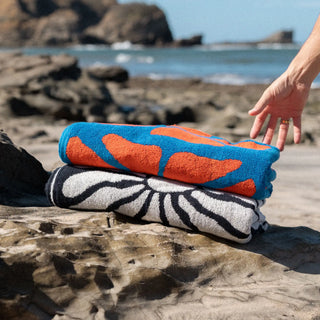 Nomadix Organic Cotton Beach Towel in Lazy Daisy Black — plush, absorbent, Fair Trade Certified™, 100% organic cotton, 30" x 72.5"